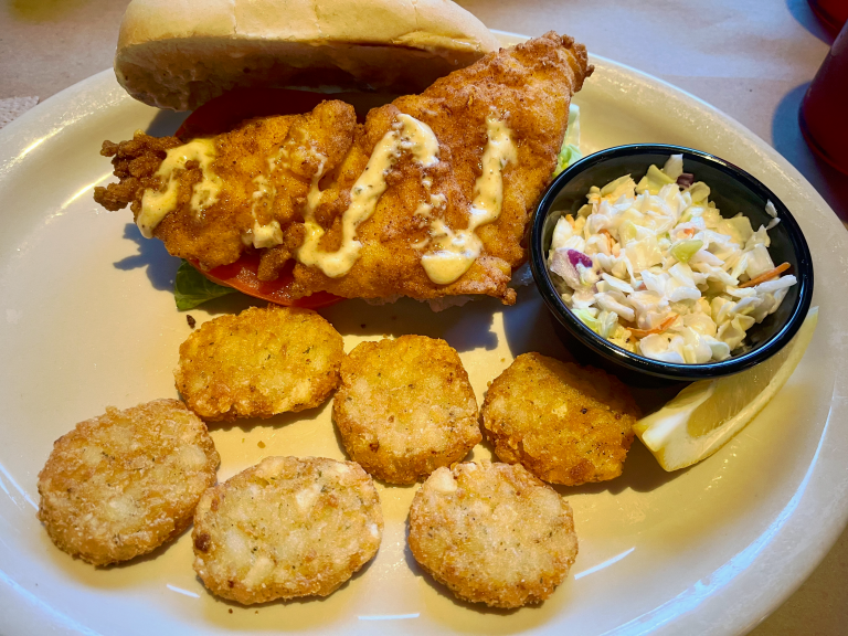 Cod sandwich with hashbrowns and coleslaw