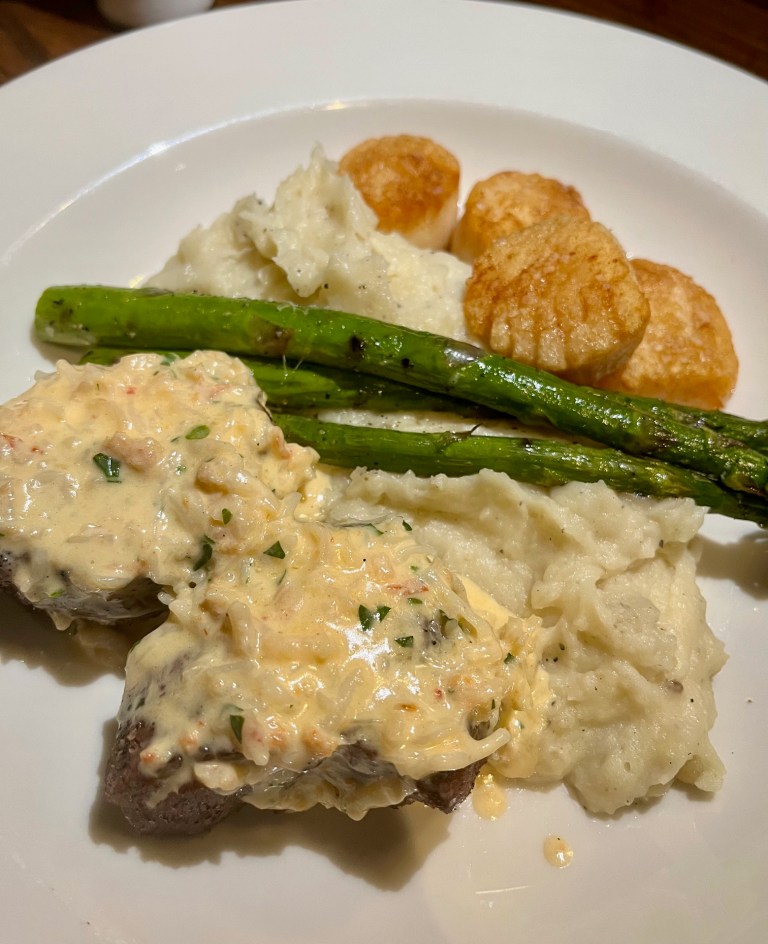 Plate of steak and scallops with asparagus